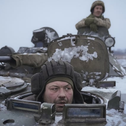 Ukrainians drive in an armored personnel carrier near the frontline position in the Luhansk area in eastern Ukraine on Friday. Photo: AP