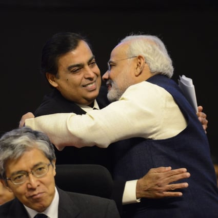 Narendra Modi, now India’s prime minister and then-chief minister of Gujarat state, embraces Mukesh Ambani in 2013. Photo: AFP