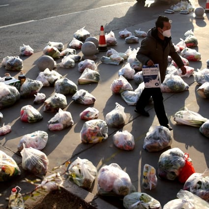 A worker prepares food supplies to be delivered to residents of a compound under lockdown in Xian, Shaanxi province, late last year. Photo: Reuters