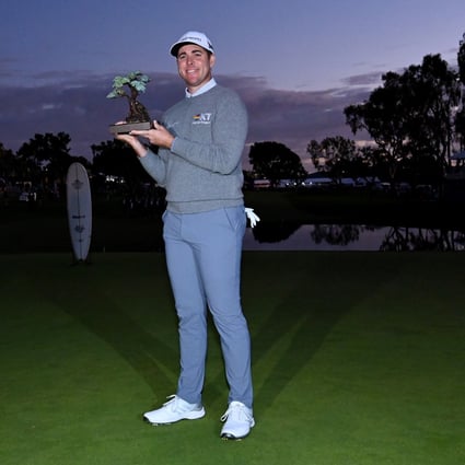 Luke List celebrates with the trophy after winning the The Farmers Insurance Open. Photo: TNS