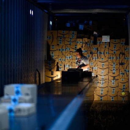 A woman works at the Amazon fulfillment centre in Staten Island, New York City, on February 5, 2019. Service wages are the only part of the price structure that the Fed’s new policy can affect directly. Photo: AFP