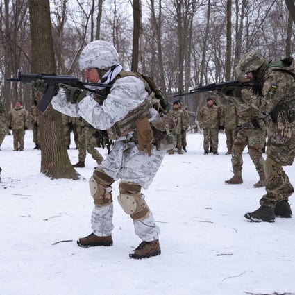 Volunteers in a Kyiv Territorial Defence unit train in a forest near Kyiv, Ukraine, on January 22. Across Ukraine, thousands of civilians are participating in such groups to receive basic combat training and, in time of war, would be under direct command of the Ukrainian military. Photo: TNS