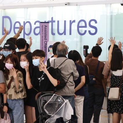 People wave goodbye to their families or friends at Hong Kong International Airport in October 2021. Photo: K. Y. Cheng