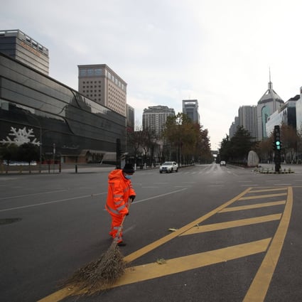 A sanitation worker sweeps a deserted road during a  coronavirus lockdown in Xian, in China’s Shaanxi province. Photo: AFP