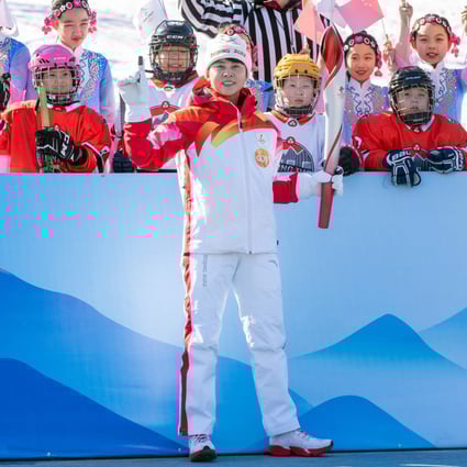 Former Chinese Olympian Wang Meng (Front) bearing the torch at the Beijing 2022 Olympic Torch Relay at the Winter Olympic Park. Photo: Xinhua   