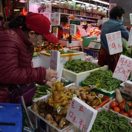 People buying fruits and vegetables at a wet market at North Point, Hong Kong. Photo: Sam Tsang