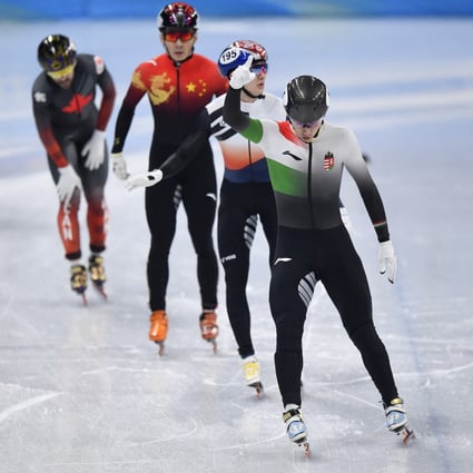 Shaoang Liu (front), Park Janghyuk, and Ren Ziwei cross the line at the end of their short-track speedskating 1,000m semi-final. Photo: Reuters