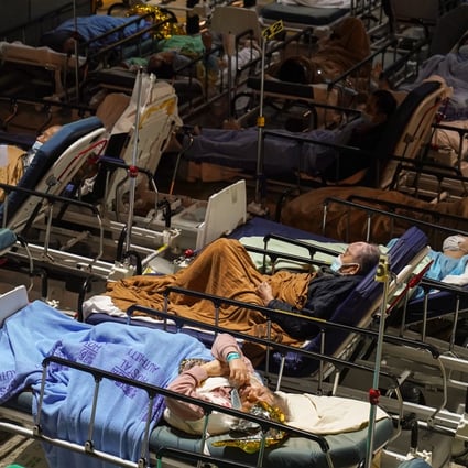 Covid-19 patients wait in a temporary holding area outside Caritas Medical Centre in Cheung Sha Wan. Photo: Sam Tsang