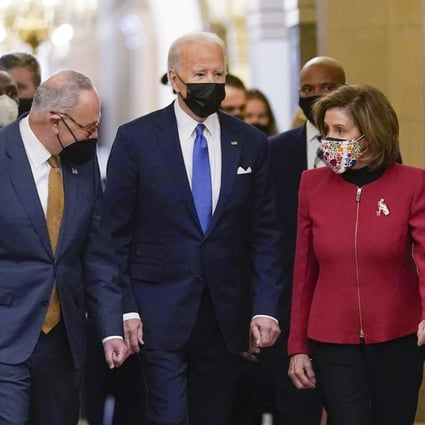 President Joe Biden is flanked by Senate Majority Leader Chuck Schumer of New York, left, and House Speaker Nancy Pelosi of California, right, after arriving on Capitol Hill in Washington on January 6, 2022.  Photo: AP