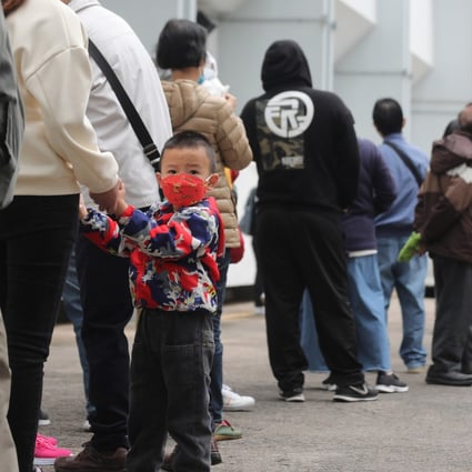 A three-year-old queues for his first Covid-19 vaccine at Yuen Wo Road Sports Centre in Sha Tin. Photo: Xiaomei Chen