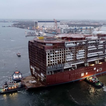 Aerial view of the 216-meter long central ship of the cruise liner “Global Dream” under construction at the Warnemuende shipyard near Rostock in northeastern Germany on November 23, 2019. Photo: dpa / AFP