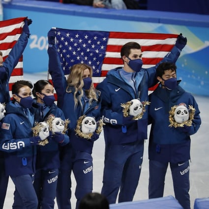 Team USA celebrate on the podium after winning silver in the figure skating mixed team competition. Photo: DPA