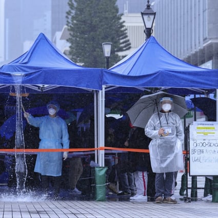 It’s a cold and wet wait for residents lining up for Covid-19 tests in Central, Hong Kong. Photo: Nora Tam