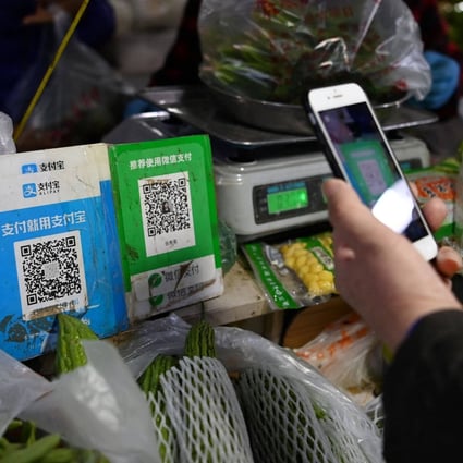 A shopper pays using a QR code at a vegetable market in Beijing. Photo: AFP