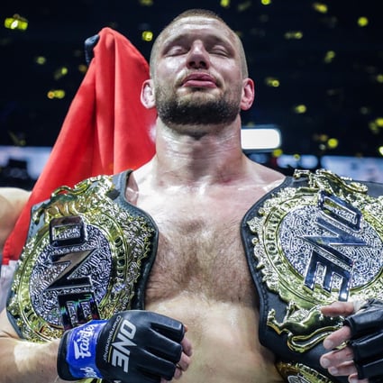 Reinier de Ridder celebrates with his two world titles. Photo: ONE Championship