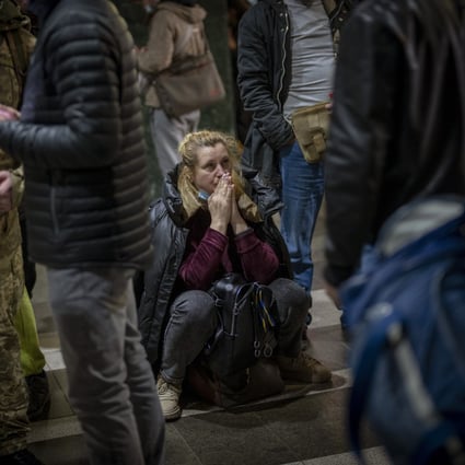 In Ukraine capital Kyiv, some try to flee, others stock up ...