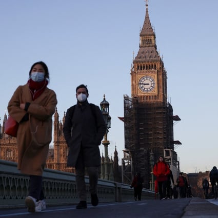 The Houses of Parliament can be seen as people walk over Westminster Bridge in London, Britain. Photo: Reuters