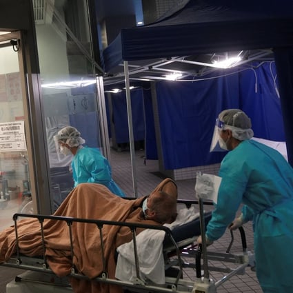 Medical workers move a patient  from a temporary treatment area into a hospital on February 18. Photo: Reuters