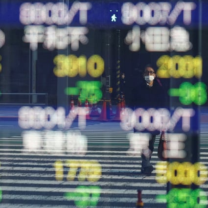 An electronic board displaying various companies’ stock prices outside a brokerage in Tokyo on, February 22, Photo: Reuters