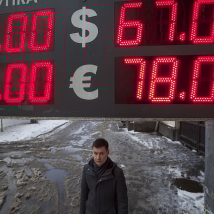 A man walks past an exchange office on a snowy Moscow street in Russia on January 12, 2015. Photo: AP