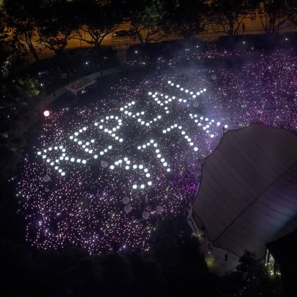 The words ‘Repeal 377A’, referencing the law that criminalises sexual acts between men in Singapore, are formed by the crowd at an LGBT event in 2019. Photo: EPA