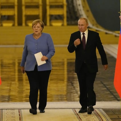 German Chancellor Angela Merkel and Russian President Vladimir Putin arrive for a joint news conference after talks in the Kremlin in Moscow on August 20 last year. Photo: EPA-EFE