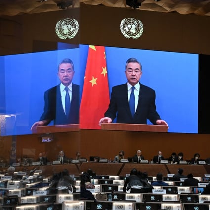 Chinese Foreign Minister Wang Yi appears on a screen as he delivers a speech at the opening of a session of the UN Human Rights Council in Geneva on Monday, following the Russian invasion in Ukraine. Photo: Reuters