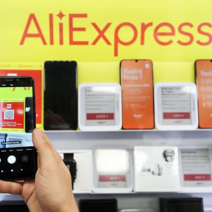 In this file photo dated August 8,  2019, an online retailer in Russia displays products in front of an AliExpress sign. Photo: Tass via Getty Images