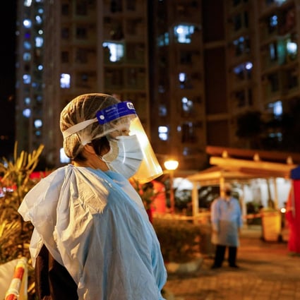 A worker outside a makeshift Hong Kong testing centre in a residential area under temporary lockdown. Photo: Reuters
