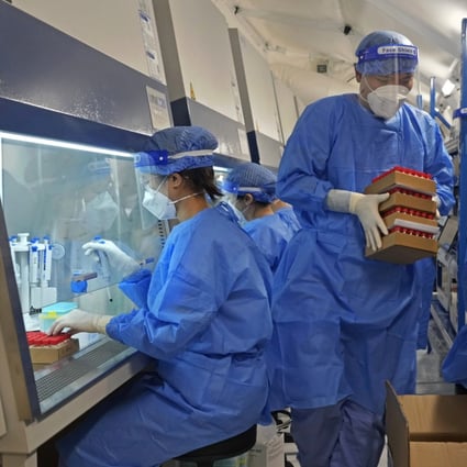 Health workers from mainland China test samples from Hong Kong residents for the coronavirus at an inflatable mobile testing lab in Hong Kong. Photo: AP