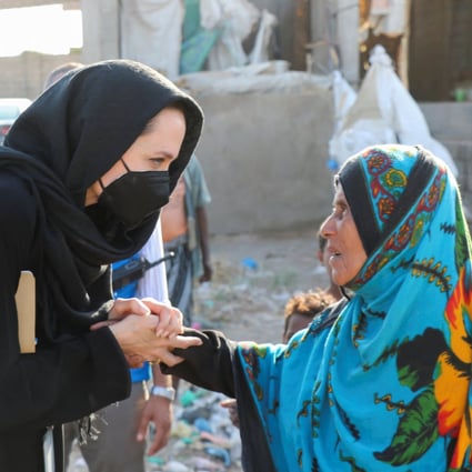 UNHCR special envoy Angelina Jolie shakes hands with a woman displaced by war during a visit to the southern province of Lahej, Yemen on March 6. Photo: Reuters