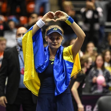 Ukraine’s Dayana Yastremska, wrapped in the Ukrainian national flag, reacts after the WTA 6eme Sens Open semi-finals in Lyon. Photo: AFP