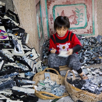 A young girl disassembles computer CD players in Guiyu, China. Bangladesh-born Mashiat Lamisa works with Projekt, a social enterprise that teaches Hong Kong people how to repair gadgets so they don’t end up as trash for poor children to disassemble, and to turn old ones into jewellery. Photo: Getty Images