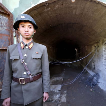 A North Korean soldier stands guard at the entrance to a tunnel at the Punggye-ri nuclear test facility in 2018. Photo: News1 / Dong-a Ilbo via AFP