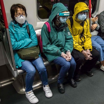 People wearing face shields and masks commute on the MTR on March 10. Universal testing and a partial lockdown may well suppress the fifth wave to a large extent, but how often can we go through the same exercise without being drained by fatigue and frustration? Photo: AFP