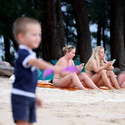 Russian tourists sit on a beach on the Thai island of Phuket on March 8. Photo: Reuters