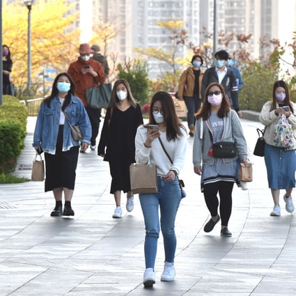 People wearing face masks walk in Tsuen Wan, Hong Kong, on Thursday. Photo: Xinhua