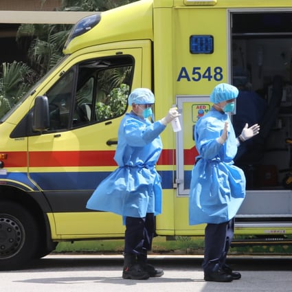 A paramedic sprays disinfectant on his colleague outside the accident and emergency department at the Queen Elizabeth Hospital in Jordan on February 28. Photo: Jelly Tse