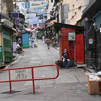 A man looks at his phone on an empty street in Hong Kong on Sunday. A minor earthquake shook parts of the city early Monday morning. Photo: AFP)