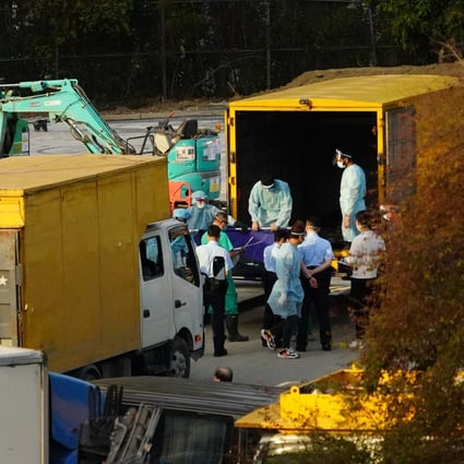Workers transfer bodies of the deceased into a refrigerated shipping container outside the Fu Shan Public Mortuary on March 11, as mortuaries are reaching capacity amid the fifth wave of Covid-19. Photo: Felix Wong