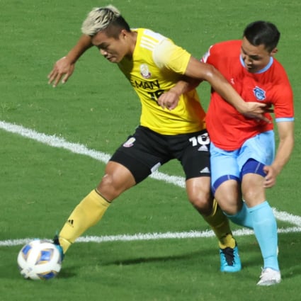 Ngan Lok-fung (yellow) of Lee Man attempts to get away from Athletic 220’s Enkhbileg Purevdorj in last year’s AFC Cup group match at Tseung Kwan O Sports Ground.  Photo: K. Y. Cheng