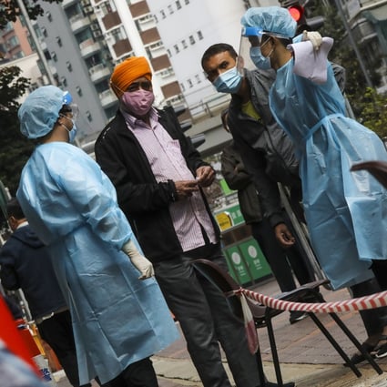 Health workers direct residents to a mandatory Covid-19 testing station after a spike in cases in Jordan and Yau Ma Tai last year. Photo: K. Y. Cheng