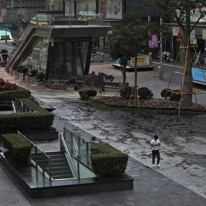 A man wearing a face mask to help protect from the coronavirus walks through a deserted pedestrian street in Huaqiangbei, the world’s biggest electronics market, in Shenzhen’s Futian district, which remains under lockdown through March 20. Photo: AP
