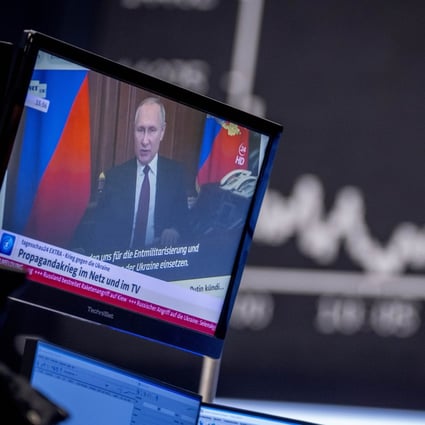 Russian President Vladimir Putin is seen on a TV screen at the stock market in Frankfurt, Germany, on February 25. Photo: AP