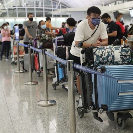 Passengers wait at check-in counters at Hong Kong International Airport on June 29, 2021. Photo: Edmond So