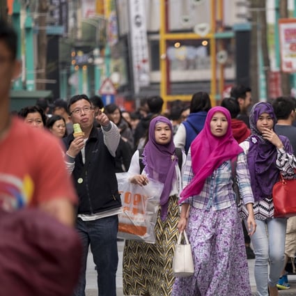 Indonesian women stroll around Taipei in 2016. Photo: Getty Images