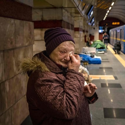 A woman weeps in a metro station being used as bomb shelter in Kyiv. Photo: AFP