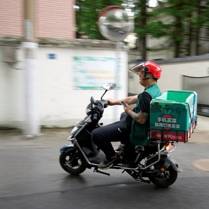 A delivery worker of Chinese online grocery Dingdong Maicai, in Shanghai in June. Photo: REUTERS