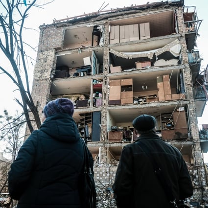 Residents look at a destroyed apartment building after Russian shelling in a neighbourhood in Kyiv on Saturday. Photo: dpa