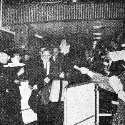 Crowds of excited fans follow Pat Boone (centre) as he exits the customs enclosure at the Kai Tak Airport in March,1964. The singer performed two concerts at City Hall.
